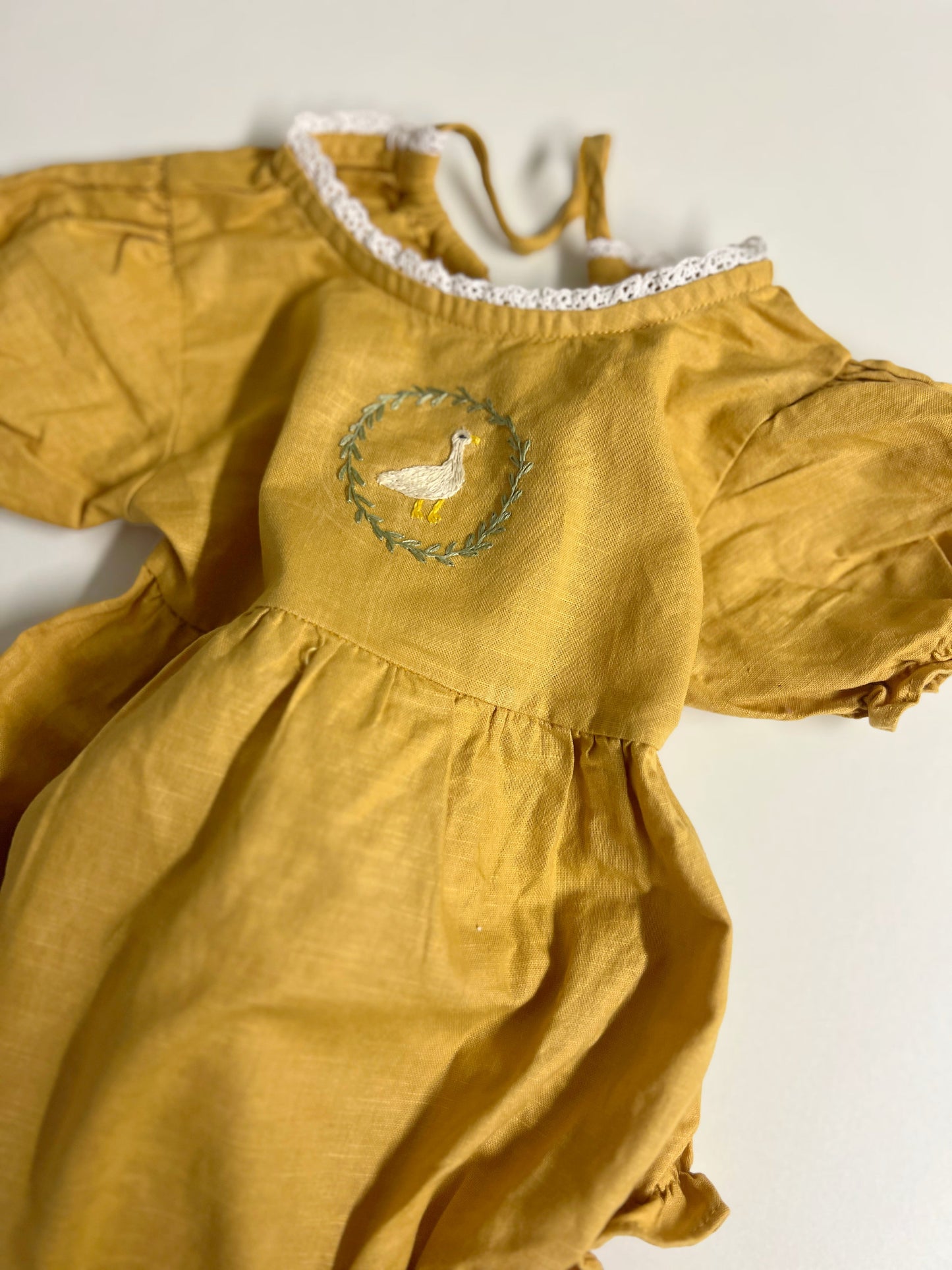 Goose in the Garden | Hand-Embroidered Linen Romper | 6–12 months