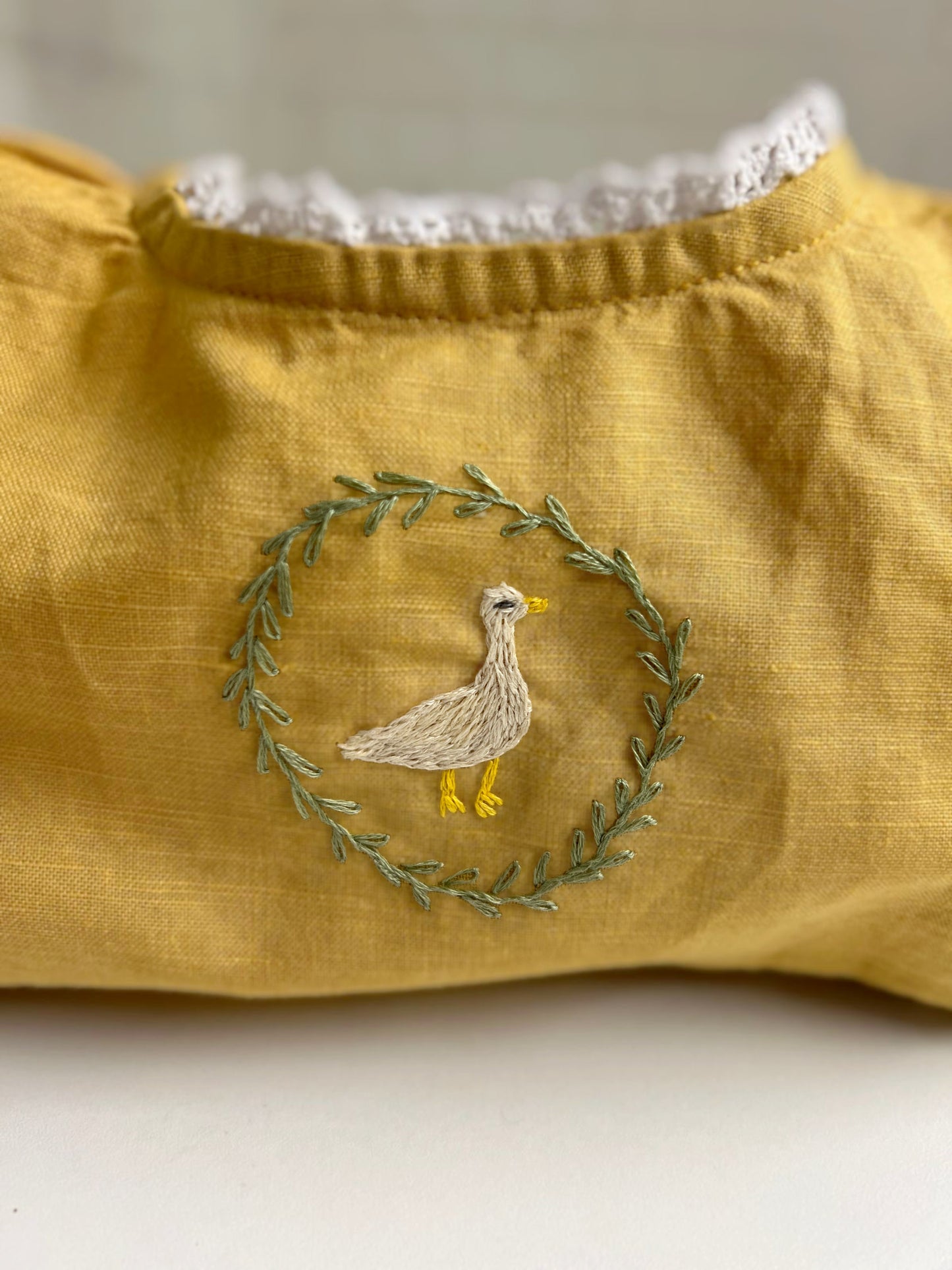 Goose in the Garden | Hand-Embroidered Linen Romper | 6–12 months