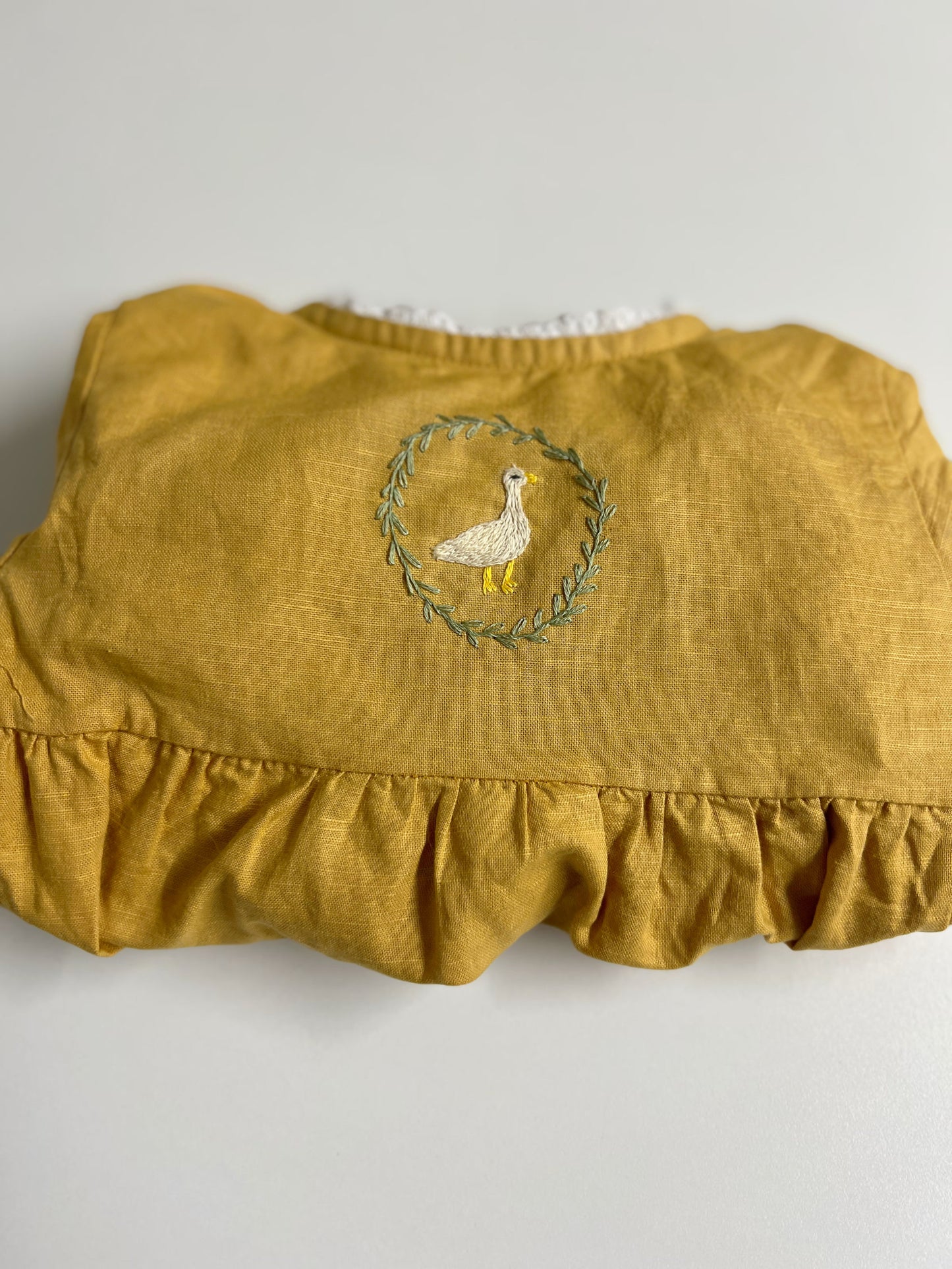 Goose in the Garden | Hand-Embroidered Linen Romper | 6–12 months