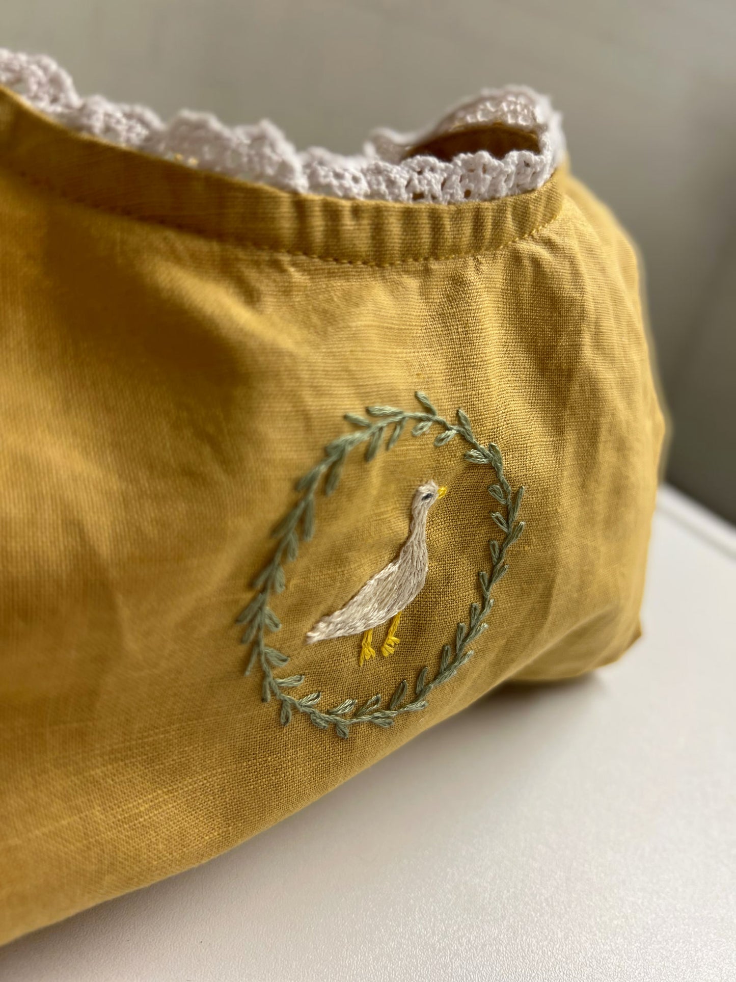 Goose in the Garden | Hand-Embroidered Linen Romper | 6–12 months